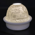 Decorative night light with engraved text and floral patterns on a black background