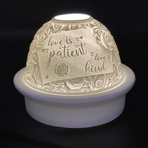 Decorative night light with engraved text and floral patterns on a black background