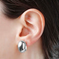 Bellissimo Bronzo Polished White Gold Plate Cabochon Earrings in an ear